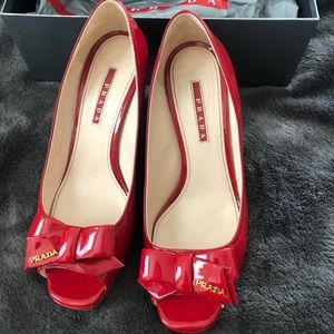 Red patent Prada wedges with bow